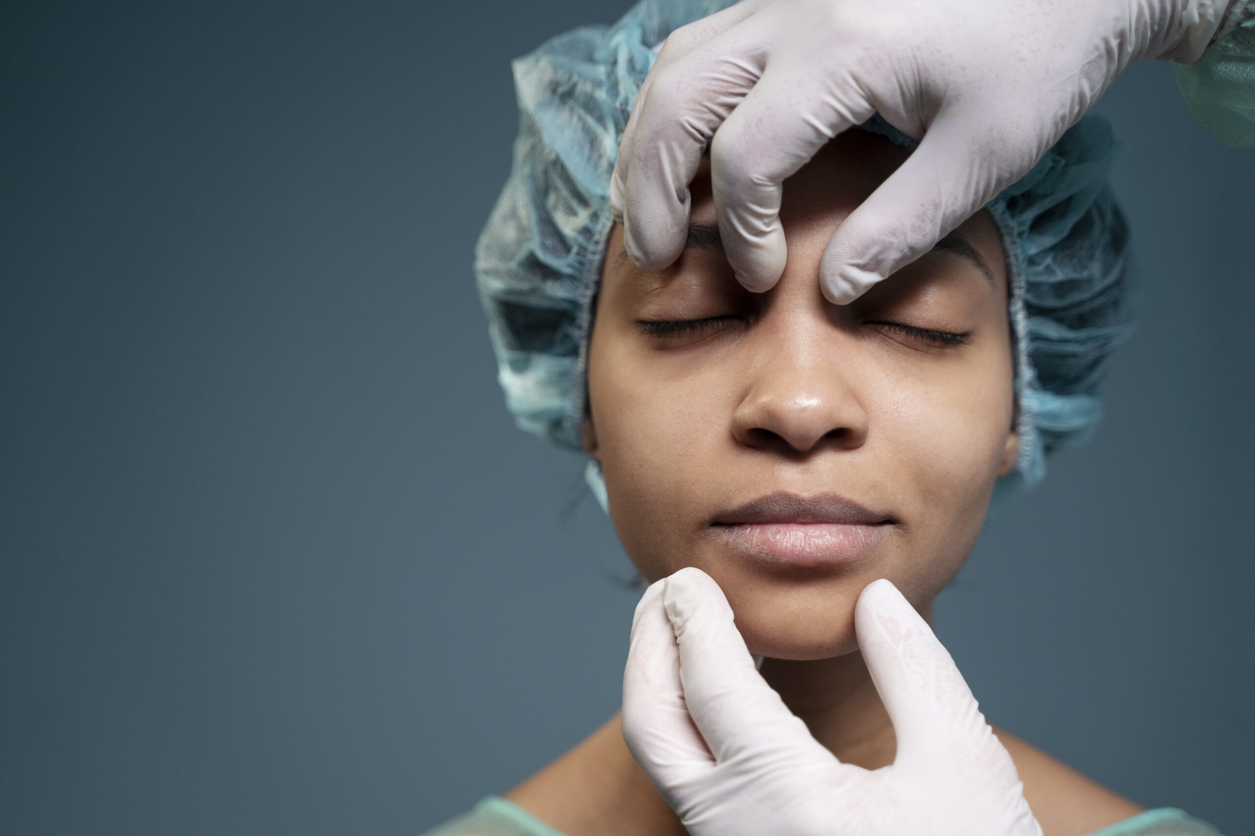 Physician examining a patient’s nasal anatomy during evaluation for rhinogenic headache